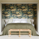Bedroom with a bed covered in green bedding, white pillows, and a wooden bench in front.