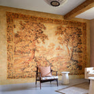 Decorative tapestry with a landscape design in a room with furniture.